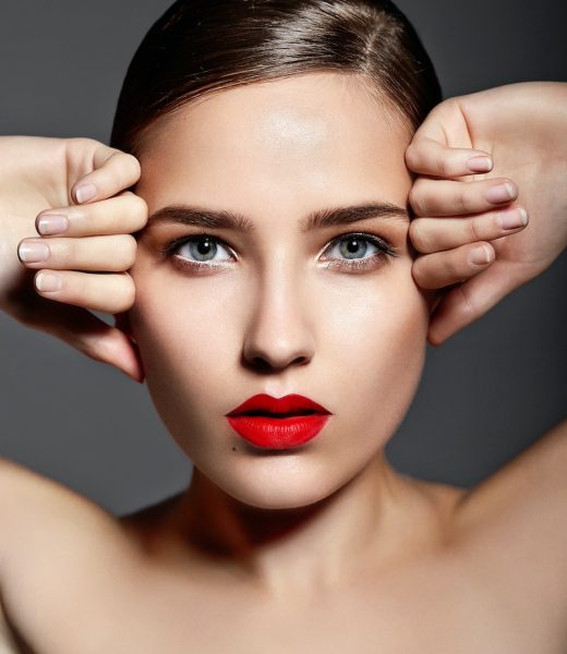 High fashion look.glamor closeup portrait of beautiful sexy stylish brunette Caucasian young woman model with bright makeup, with red lips,  with perfect clean skin in studio